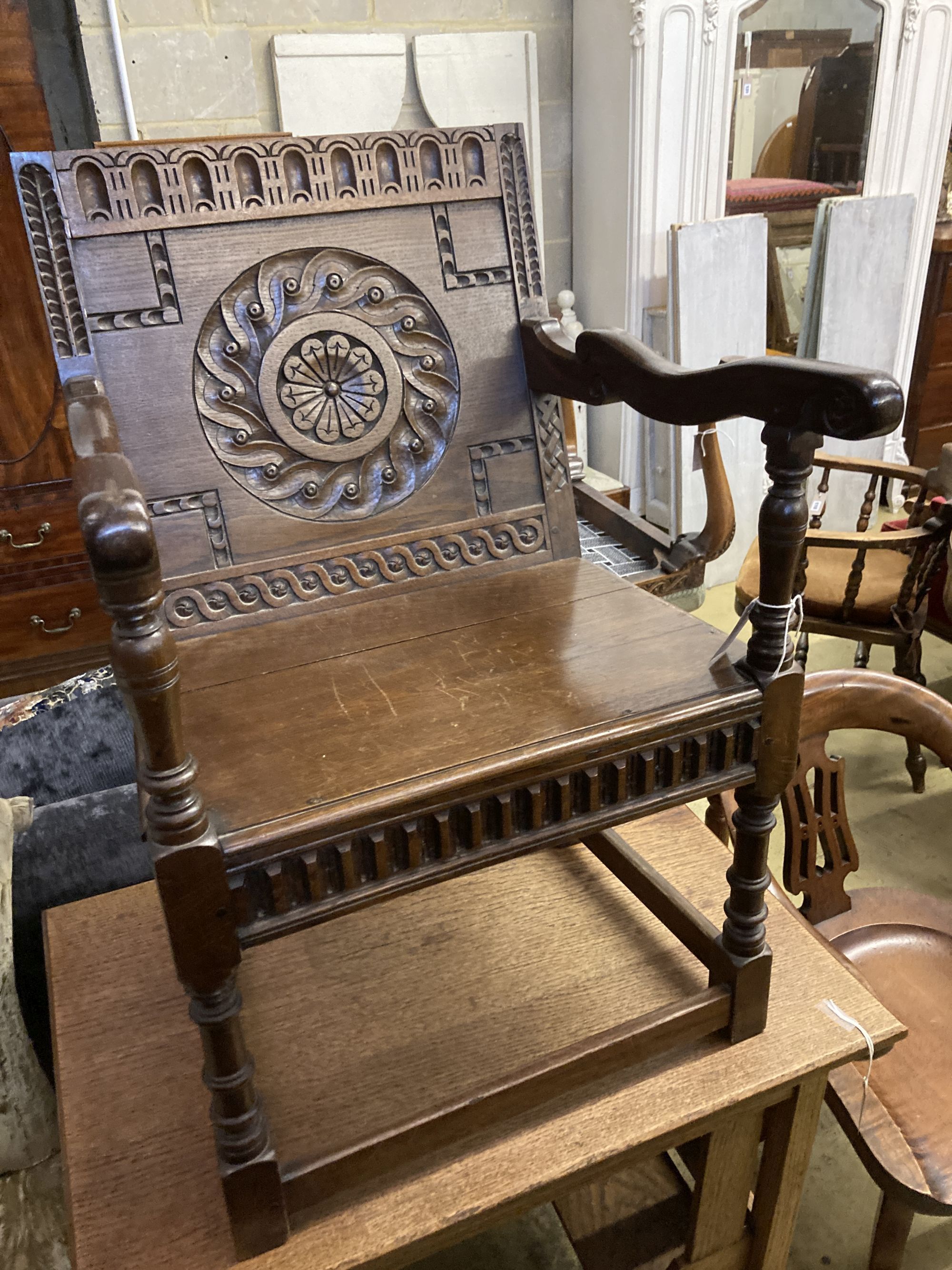 An 18th century style oak wainscot type elbow chair, width 58cm, depth 45cm, height 89cm